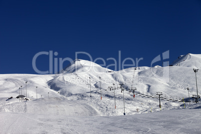 Winter mountains and ski slope at sun day