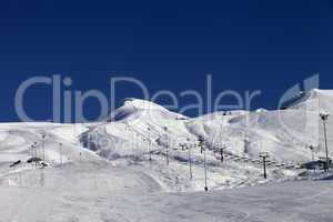 Winter mountains and ski slope at sun day