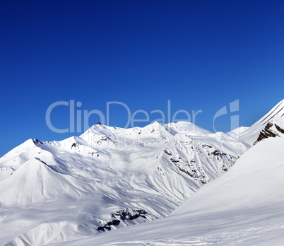 View on ski slope and beautiful mountains at sun day