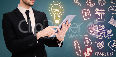 Composite image of mid section of a businessman using digital ta