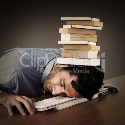 Composite image of businessman sleeping with his head on the key