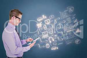 Composite image of handsome businessman using tablet