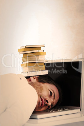 Composite image of businessman resting head on laptop keyboard