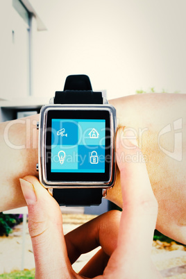 Composite image of woman using smartwatch