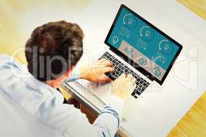 Composite image of man using laptop