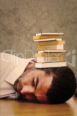 Composite image of tired businessman resting on his desk