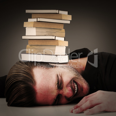 Composite image of stressed businessman banging his head