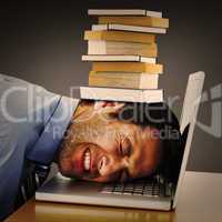 Composite image of businessman resting head on keyboard