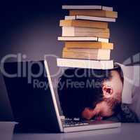 Composite image of exhausted businessman sleeping head on laptop