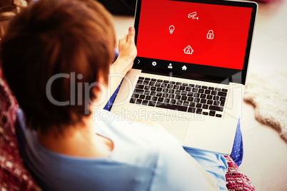 Composite image of pregnant woman using her laptop