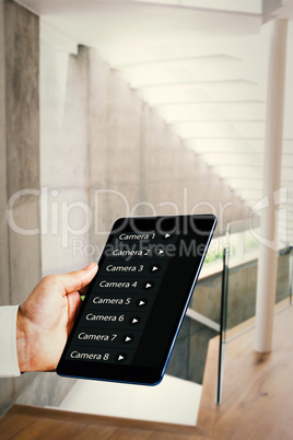 Composite image of man using tablet pc