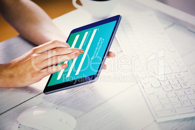 Composite image of woman using tablet at work