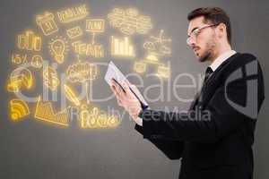 Composite image of businessman with glasses using his tablet