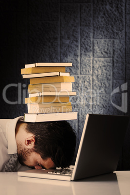 Composite image of exhausted businessman sleeping head on laptop