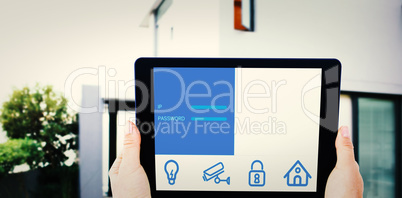 Composite image of businesswoman holding digital tablet