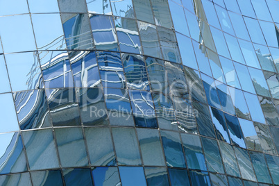 Reflection in windows of modern office building