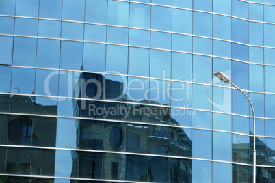 Reflection in windows of modern office building