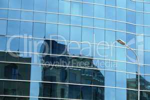 Reflection in windows of modern office building