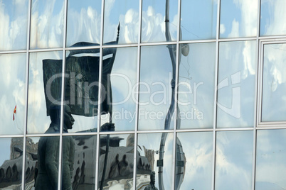 Reflection in windows of modern office building