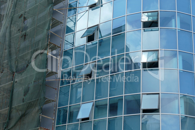 Reflection in windows of modern office building