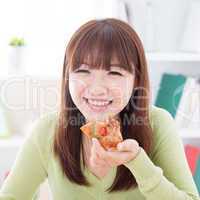 Asian girl eating pizza