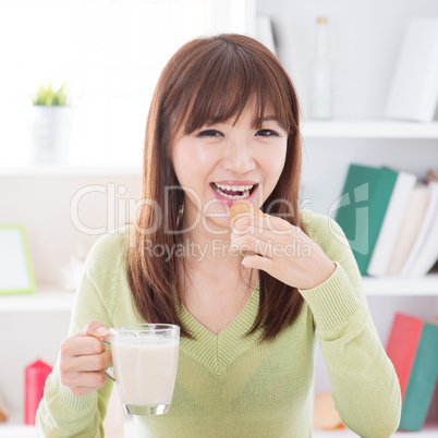 Asian female eating cookies