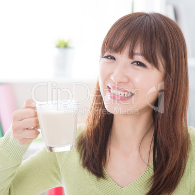 Asian female drinking dairy milk