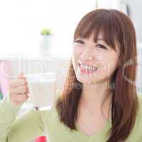 Asian female drinking dairy milk