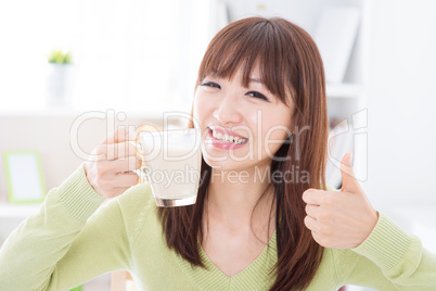 Asian female drinking milk and thumb up