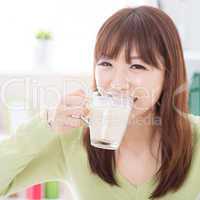 Asian female drinking milk
