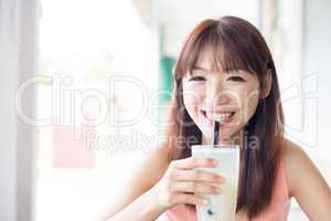 Woman drinking beverage at cafe