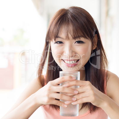 Woman drinking water at cafe