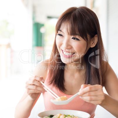 Asian girl eating noodles