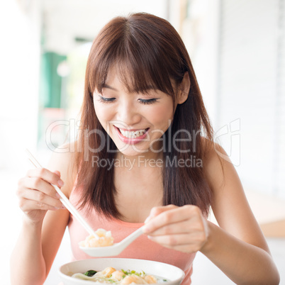 Chinese girl eating noodles