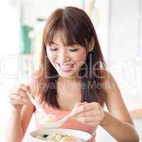Chinese girl eating noodles