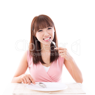 Dining concept, woman eating with empty plate