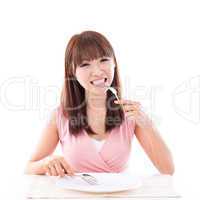 Dining concept, woman eating with empty plate