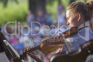 Young woman playing the violin at outdoors