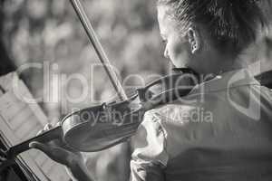Young woman playing the violin at outdoors