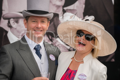 Couple at Royal Ascot laughing at camera