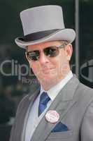 Man in grey top hat and sunglasses