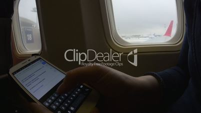 Online hotel search on phone in plane