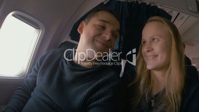 Young loving couple in the plane