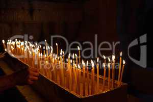 Rows of burning candles .