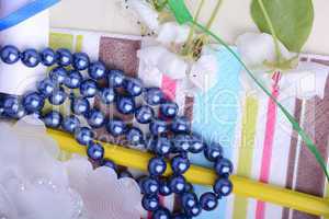 Office table with flower, ribbons, pencils, pearls