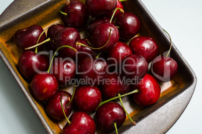 Cherries in a rustic ceramic bowl