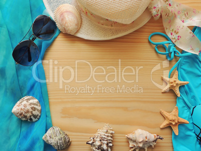 Summer sea composition on wooden background.