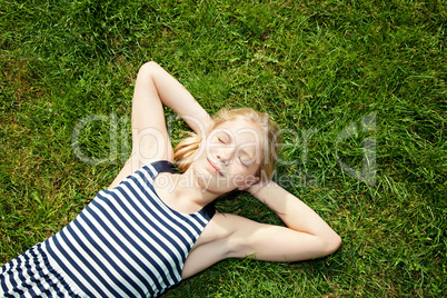 young girl lying on grass