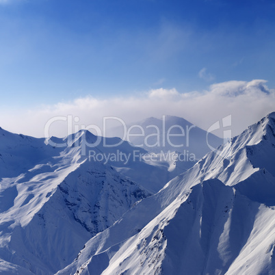 Snowymountains in early morning fog