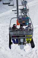 Snowboarders on chair-lift